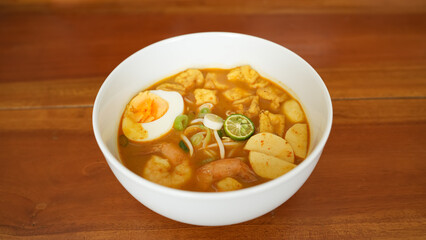 Laksa, creamy spicy soup made with a coconut milk base. Common ingredients include noodle, shrimp, tofu, boiled egg
