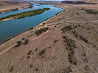 The Ili River and the sandy coastal area. The largest river in Semirechye. The view from the drone. Summer time of the year.