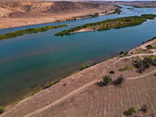 The Ili River and the sandy coastal area. The largest river in Semirechye. The view from the drone. Summer time of the year.