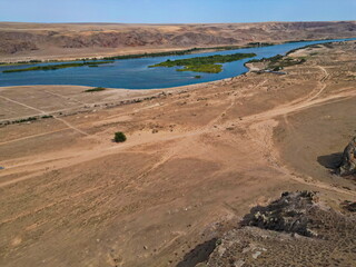 The Ili River and the sandy coastal area. The largest river in Semirechye. The view from the drone. Summer time of the year.
