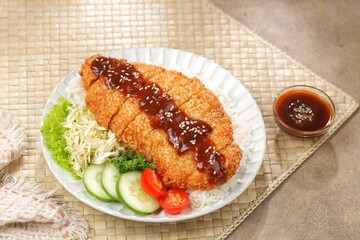 Ayam Teriyaki. Teriyaki chicken katsu is a Japanese dish consisting of pieces of chicken cooked in a sweet and savory teriyaki sauce. Teriyaki sauce is made from soy sauce, sugar, and spices.