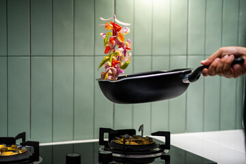 Culinary Skills cooking. Chef Expertly Stir-fries Vibrant Vegetables. Man mixing ingredient many...