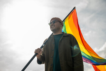LGBTQ gay celebration moment on Pride month Parade of LGBT community festival. Bisexual man gay Pride Parade with rainbow flag. LGBT and homosexual concept.