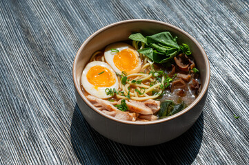 Ramen soup in cafe on wooden table. 