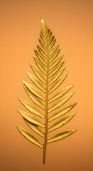 Photo of a Golden Leaf with Detailed Texture on a Brownish Gradient Background