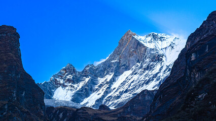 Mt. Fishtail (Machapuchare) Himalayan Snow Peak at Dusk under Blue Sky