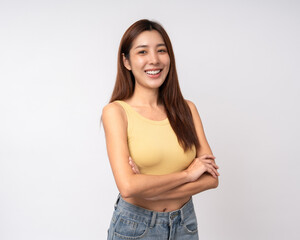 Beautiful smiling happy young asian woman in yellow shirt. Charming female lady standing pose on isolated white background. Asian woman people looking camera confident with backdrop.