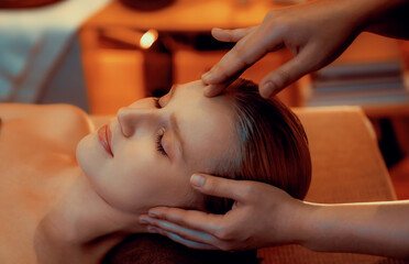 Closeup caucasian woman enjoying relaxing anti-stress head massage and pampering facial beauty skin...