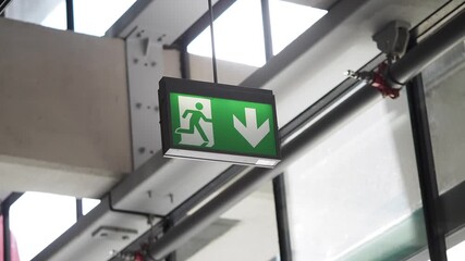 Emergency exit sign guiding people to safety indoors - Powered by Adobe