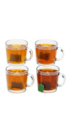 Photo of Four Transparent Glass Mugs of Brewed Tea Isolated on Black Background