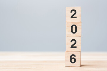wooden cube block with 2026 text on table background. Resolution, plan, review, goal, start and New Year holiday concepts