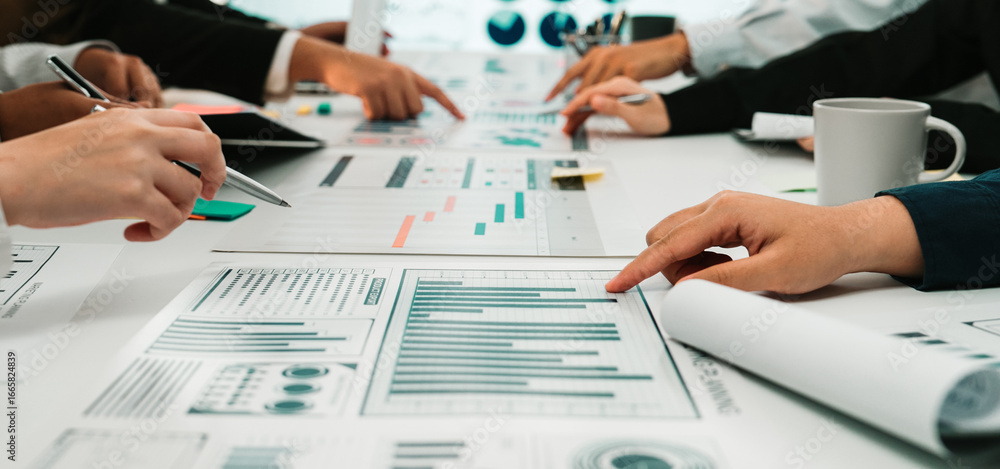Poster a collaborative business meeting featuring diverse hands engaged in the analysis of data charts and 
