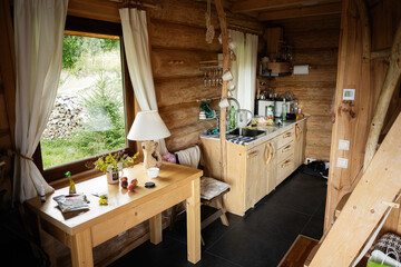 Cozy wooden cabin interior with natural light and rustic kitchen design