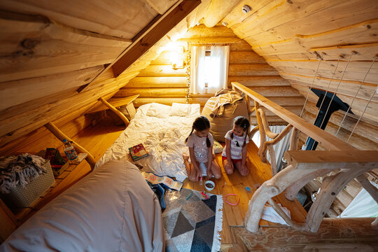 Cozy wooden loft with children playing and relaxing during a peaceful evening