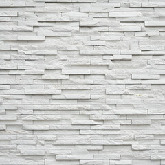 White stone veneer wall, featuring a horizontal pattern of rectangular, layered stone elements. Elegant, minimalist wall cladding for commercial interior or exterior use.