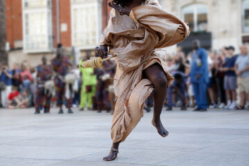 Woman dancing and wearing one of the traditional folk costume from Dakar, Senegal