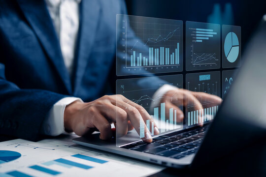 Businessman using laptop with financial charts and data analytics overlaying the screen for business technology insights