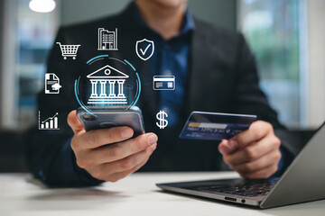 Modern finance technology hand holding phone and credit card with financial icons floating above