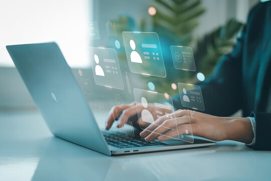 Modern business person using laptop with glowing digital network overlay for technology and innovation concept