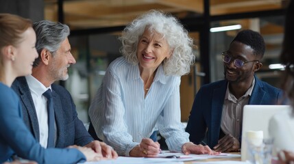senior older female executive ceo and happy multicultural business people discuss corporate project at boardroom table smiling diverse corporate team working together in modern meeting room office no