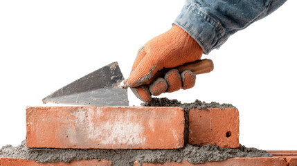 Hand holding trowel, laying bricks for construction, white isolated background.