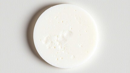 A white circle with a textured surface.