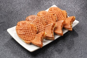 Bungeoppang Taiyaki is a popular Japanese fish-shaped cake filled with red bean jam, usually sold as a street food.