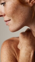 Redheaded woman with freckled skin touching delicate neck, highlighting natural beauty and personal confidence in authentic self portrayal