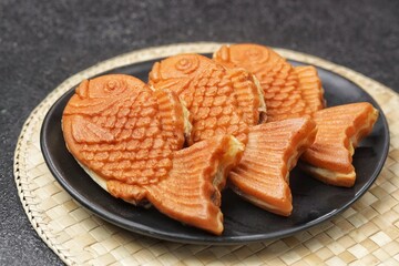 Bungeoppang Taiyaki is a popular Japanese fish-shaped cake filled with red bean jam, usually sold as a street food.