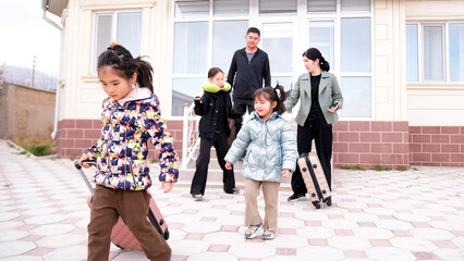 A long-awaited family vacation at sea. Dad, mom and three little daughters with suitcases leave the...