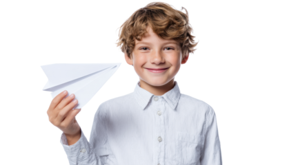 Boy holding a paper airplane, smiling brightly against a white background.