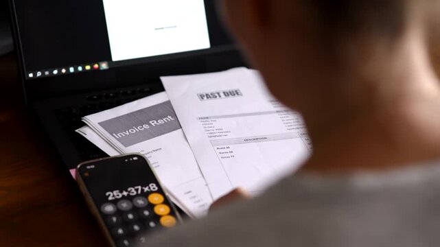Calculating overdue bills and rent invoice on smartphone