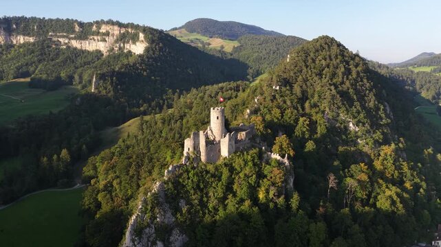 Ruin of Neu Falkenstein Castle, castle ruin in the swiss mountains. Aerial drone video.