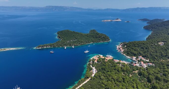 Boats Off Coast of Mljet Island in Blue Adriatic Sea in Croatia AERIAL