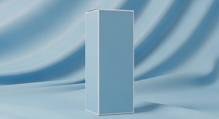 A tall, light blue product box mockup standing on a draped, silky fabric background for cosmetic or perfume packaging.