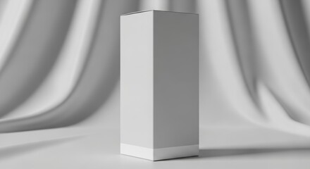 Tall white rectangular product box mockup standing upright against a soft, draped white fabric background, ideal for branding.
