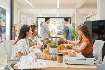 Creative ESG brainstorming session for earth friendly reuse recycle packaging campaign. Team...