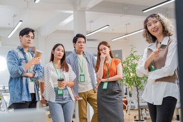 Asian business creative marketing team brainstorming startup strategy using glassboard and sticky...