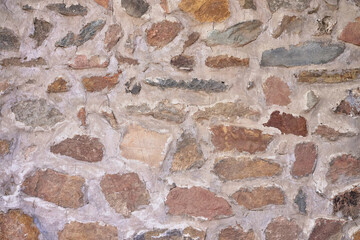 A Natural Stone Wall Texture Showing Irregular Cobblestones Mortared Together for Exterior Building Construction and Landscaping Projects