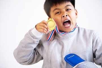 Boy fencer is happy with his victory, holding and showing off gold medals on white background