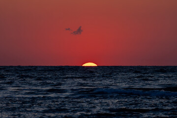 Sunset with vibrant colors like red, orange, and yellow.Sunset at sea