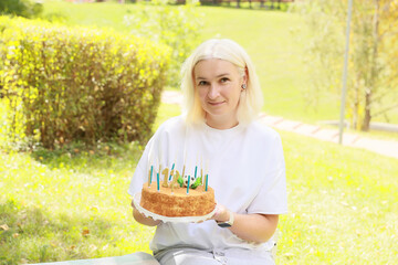 Celebrating a Joyful Birthday Moment With a Delicious Cake and Cheerful Candles in a Sunny Park