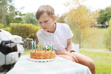 Celebrating a Joyful Moment With a Soccer-Themed Birthday Cake Outdoors on a Sunny Day Full of...
