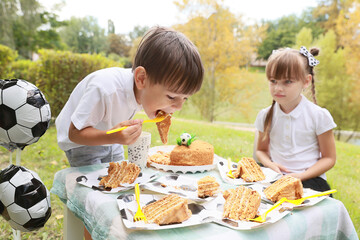 Celebrating Joy With Cake and Soccer-Themed Decor at a Delightful Outdoor Gathering for Children in the Colorful Fall Season