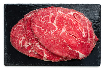 Raw premium Wagyu beef slide on Black plate on wooden background, high-quality meat cut for gourmet cooking and fine dining on plate.	
