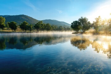 Misty lake sunrise, calm water, trees, mountains