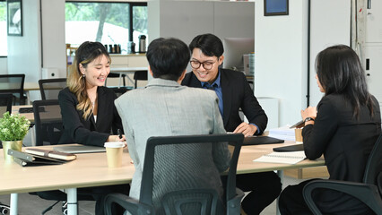 Group of business people and software developers working as a team in office