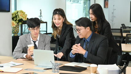Business team working on a laptop computer.
