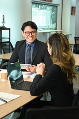 Two young colleagues working together at modern office