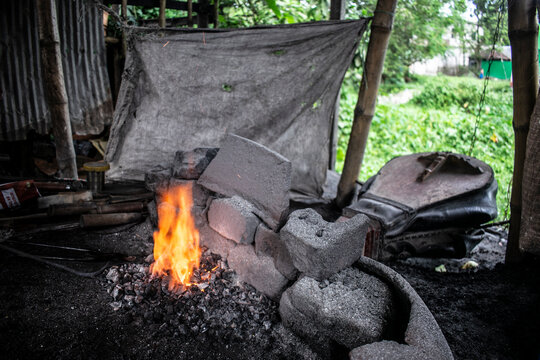 A bellows is a type of air blowing device used by blacksmiths to fan a coal fire. This fire is used to heat metal, mainly iron, and then hammer it into various shapes.bangladeshi local